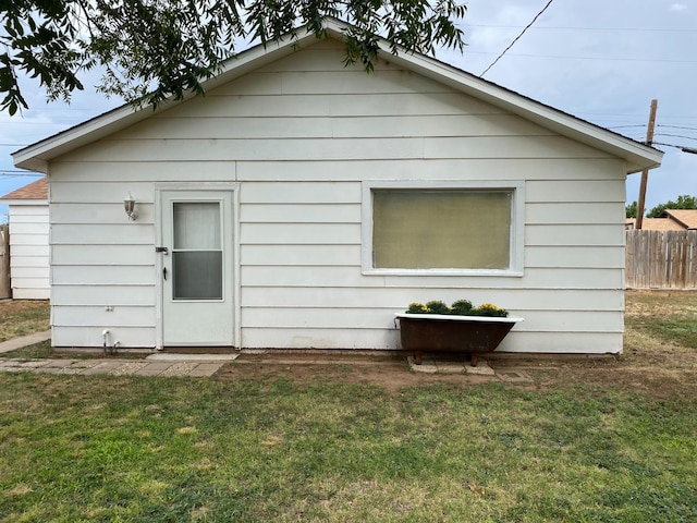 rear view of property with a lawn