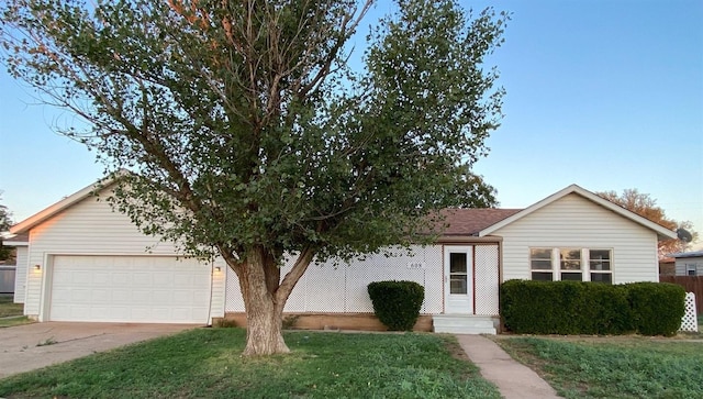 ranch-style home with a garage and a front yard