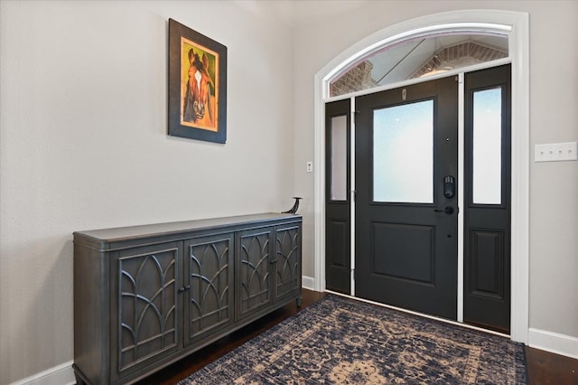 entrance foyer with baseboards and dark wood-style floors