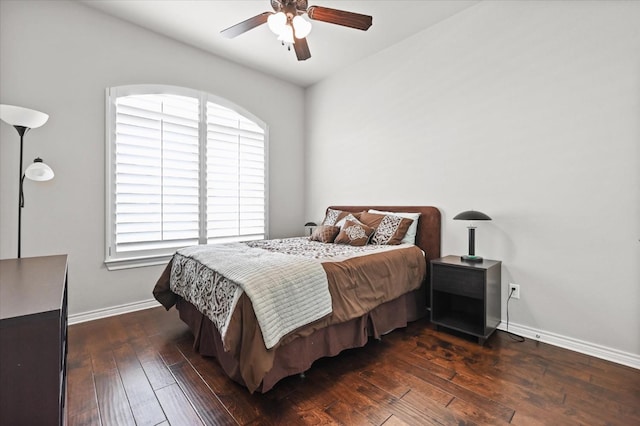 bedroom featuring ceiling fan, baseboards, and dark wood finished floors