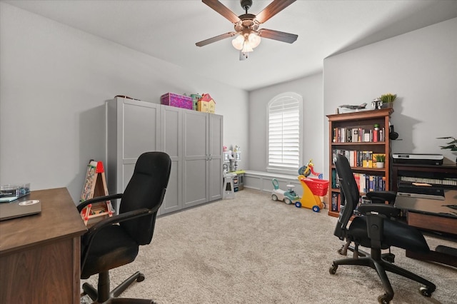 home office with carpet and a ceiling fan