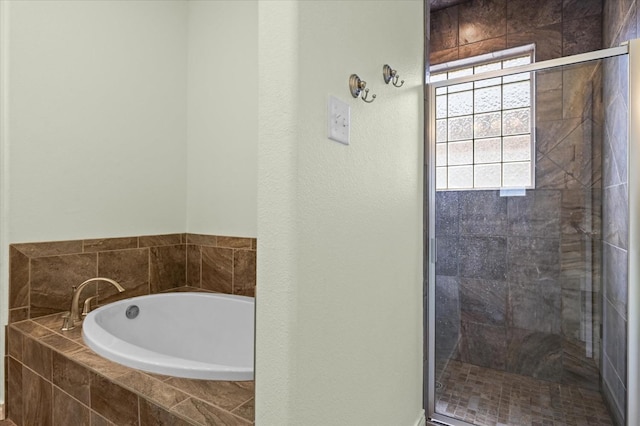 full bathroom featuring a shower stall and a garden tub