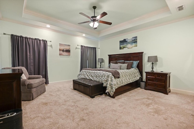 bedroom with visible vents, crown molding, a raised ceiling, and carpet