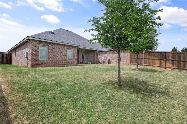 back of house with a yard