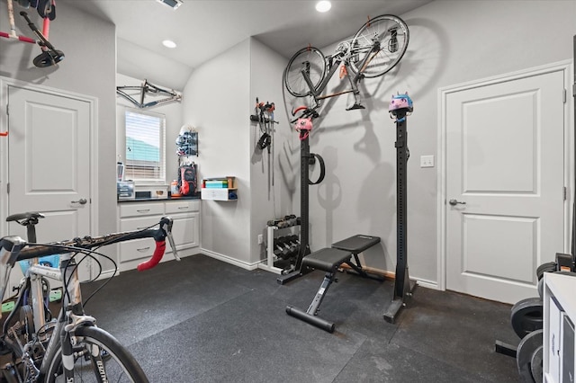 exercise room with recessed lighting and baseboards