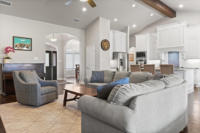 living room with lofted ceiling with beams, ceiling fan, and light hardwood / wood-style flooring