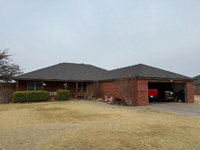 view of home's exterior featuring an attached garage, driveway, a shingled roof, and a porch