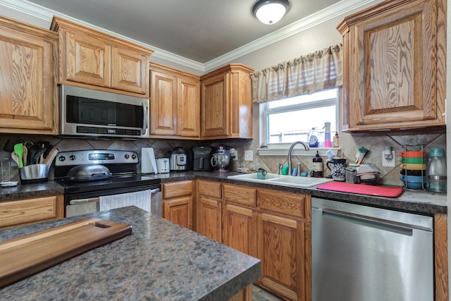 kitchen featuring stainless steel appliances, a sink, dark countertops, backsplash, and crown molding
