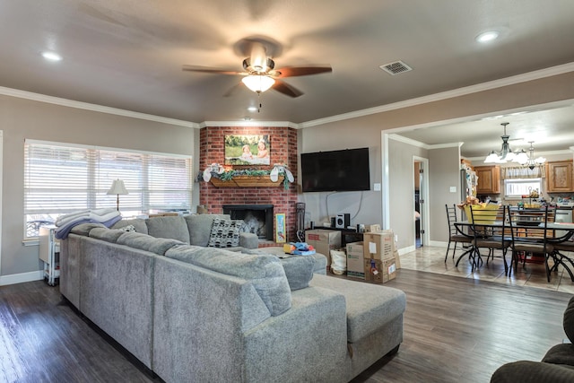 living area featuring a ceiling fan, baseboards, a fireplace, dark wood-style flooring, and crown molding