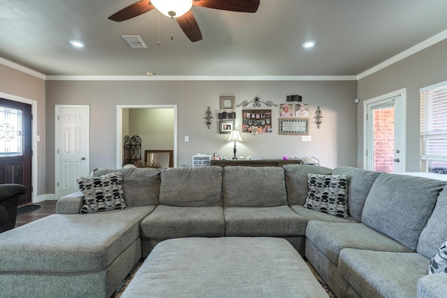living room with ornamental molding, ceiling fan, healthy amount of natural light, dark wood finished floors, and recessed lighting