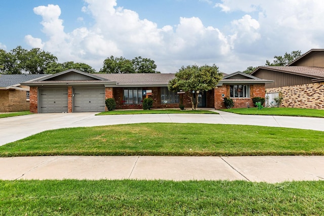 single story home featuring a garage and a front lawn