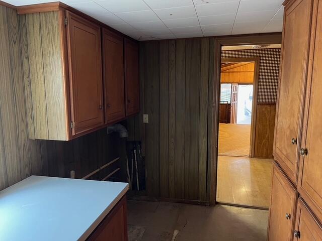 3193 US Highway 385, Littlefield, TX 79339 - kitchen with brown cabinets, light countertops, and wood walls