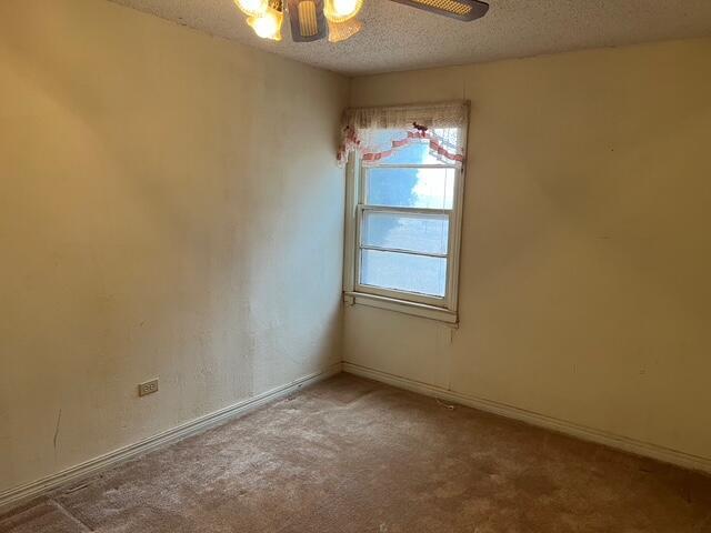 3193 US Highway 385, Littlefield, TX 79339 - carpeted spare room featuring baseboards, a textured ceiling, and a ceiling fan