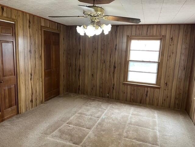 3193 US Highway 385, Littlefield, TX 79339 - spare room with a ceiling fan, carpet floors, and wooden walls