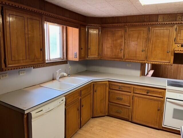 3193 US Highway 385, Littlefield, TX 79339 - kitchen featuring a sink, brown cabinetry, and white appliances