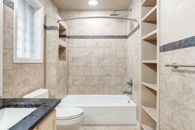 full bathroom with vanity, tiled shower / bath, tile patterned floors, and toilet