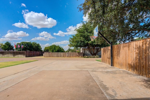 view of patio featuring basketball hoop