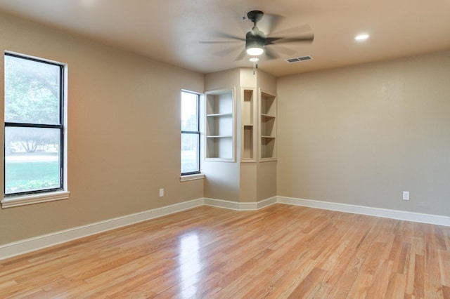 empty room with ceiling fan and light wood-type flooring