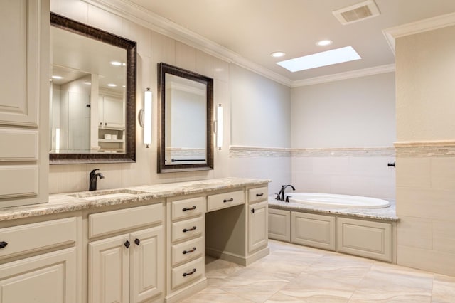 bathroom with a skylight, tile walls, a bathtub, vanity, and crown molding