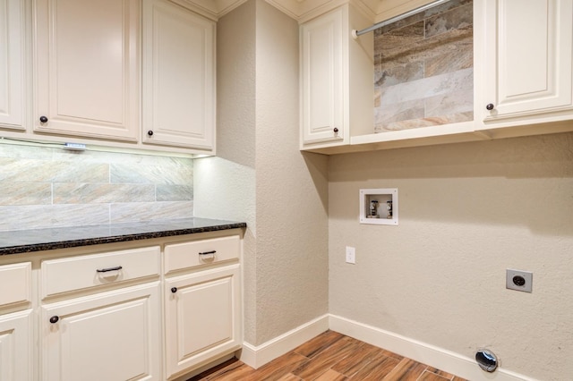 laundry area featuring hookup for a washing machine, electric dryer hookup, cabinets, and light wood-type flooring