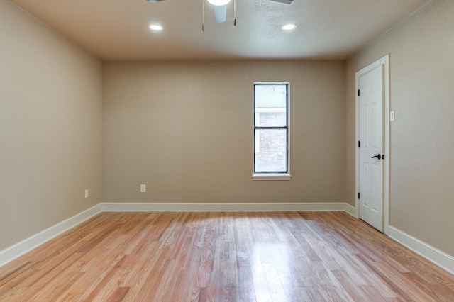 empty room with ceiling fan and light wood-type flooring