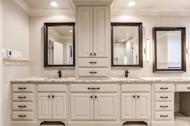 bathroom with vanity, tile walls, and crown molding