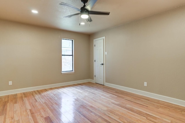 empty room with ceiling fan and light wood-type flooring