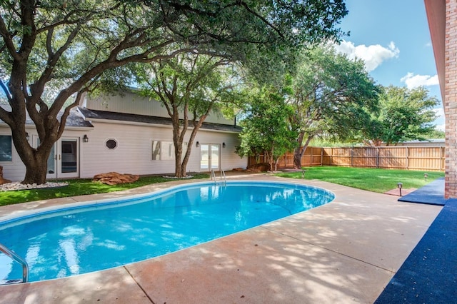 view of swimming pool with a yard and a patio area