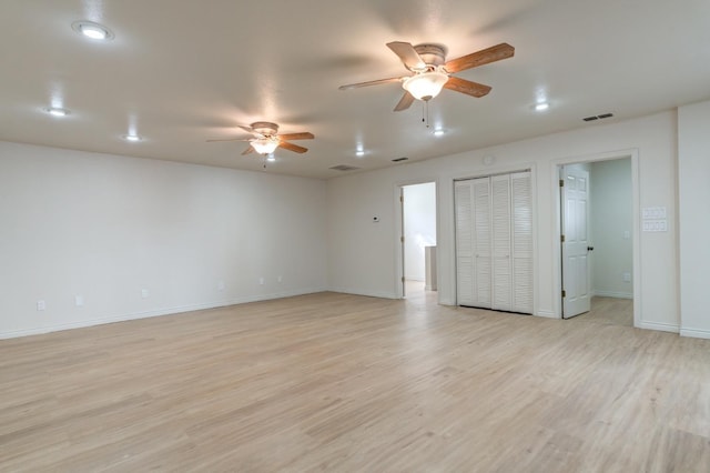 empty room featuring ceiling fan and light wood-type flooring