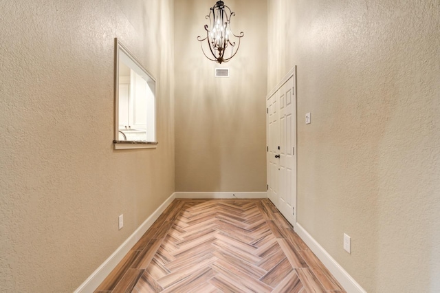 doorway featuring a notable chandelier