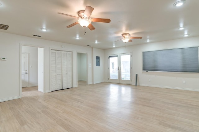 unfurnished living room featuring french doors, ceiling fan, electric panel, and light wood-type flooring