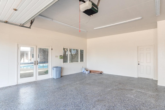 garage featuring a garage door opener and french doors