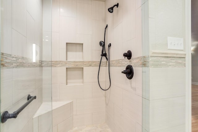 bathroom with tiled shower