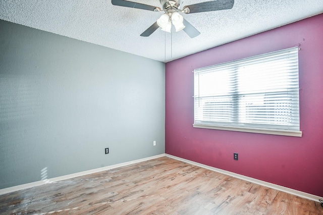 spare room with ceiling fan, light hardwood / wood-style floors, and a textured ceiling