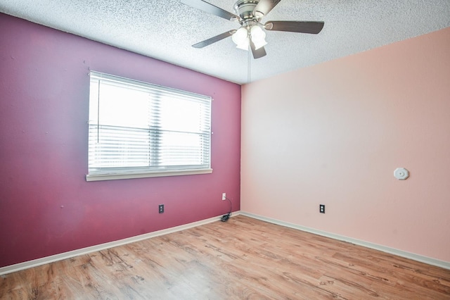 empty room with ceiling fan, a textured ceiling, and light hardwood / wood-style floors