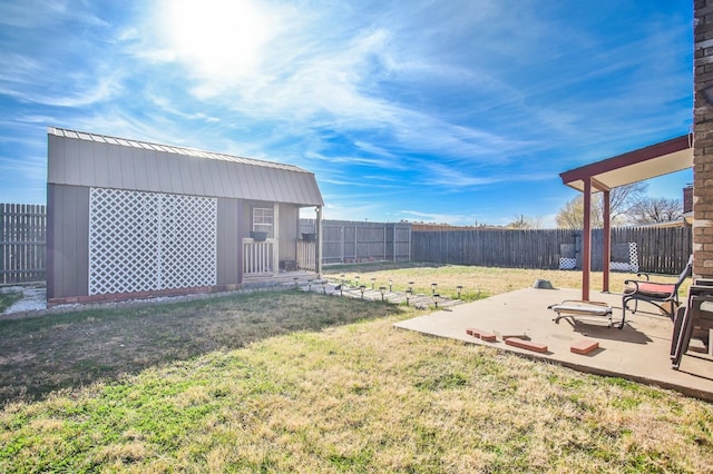 view of yard with a shed and a patio area