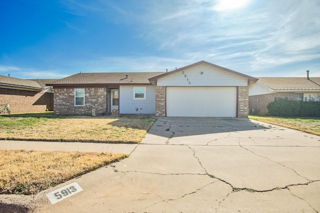 ranch-style home featuring a garage, a front yard, and central air condition unit