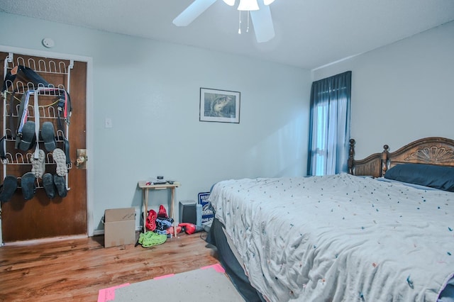 bedroom featuring wood-type flooring and ceiling fan