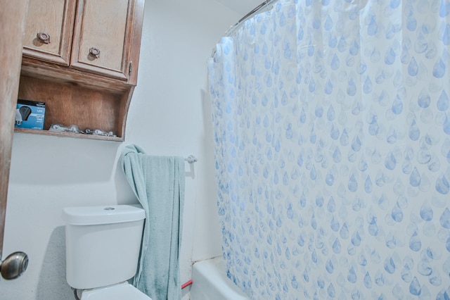 bathroom featuring shower / bath combination with curtain and toilet