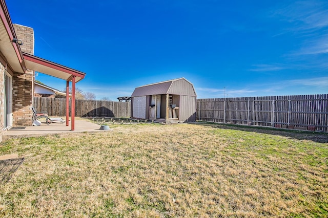 view of yard featuring a storage unit and a patio