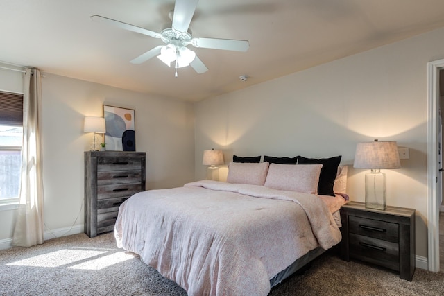 bedroom featuring baseboards, ceiling fan, and carpet