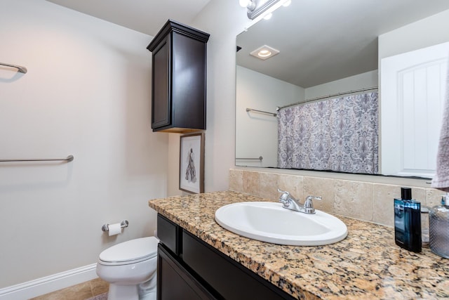 full bathroom featuring a shower with curtain, vanity, tile patterned floors, toilet, and baseboards