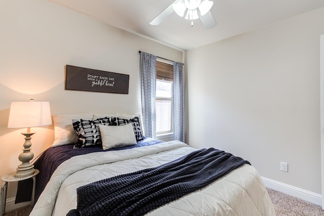 carpeted bedroom with a ceiling fan and baseboards