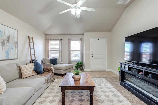 living room featuring a ceiling fan, visible vents, lofted ceiling, and plenty of natural light