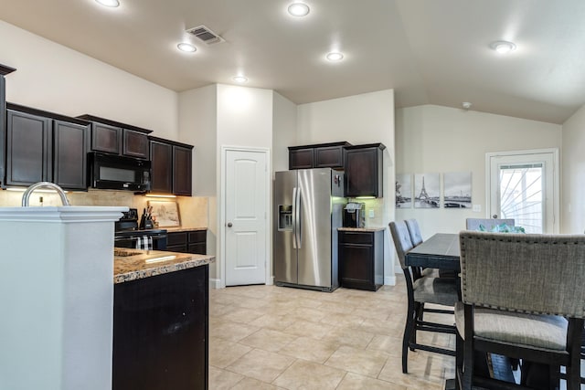 kitchen with tasteful backsplash, black appliances, visible vents, dark brown cabinets, and lofted ceiling