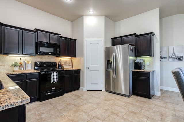 kitchen with baseboards, black appliances, decorative backsplash, and light stone counters