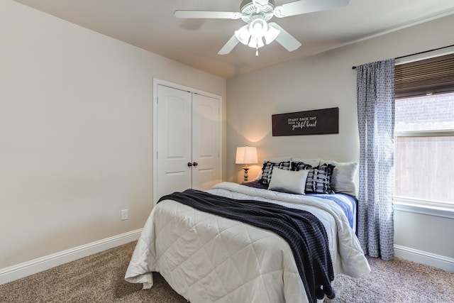 carpeted bedroom featuring baseboards, ceiling fan, and a closet