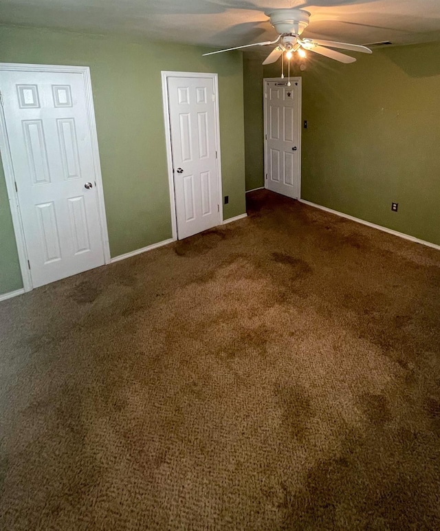 unfurnished bedroom featuring ceiling fan and carpet