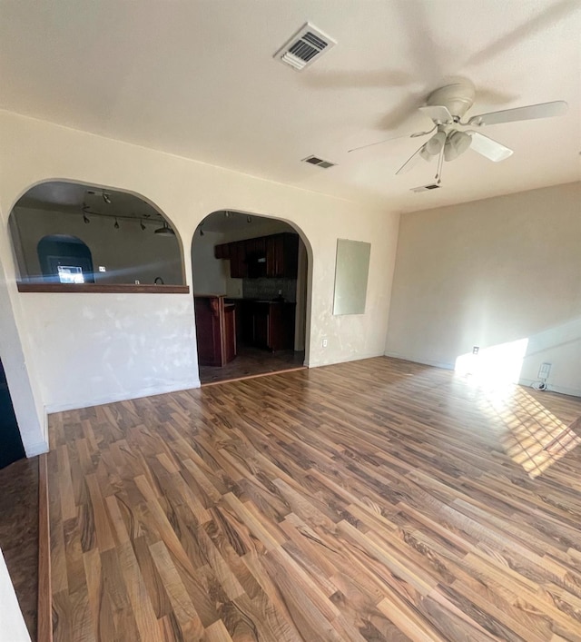 unfurnished living room featuring ceiling fan and hardwood / wood-style floors