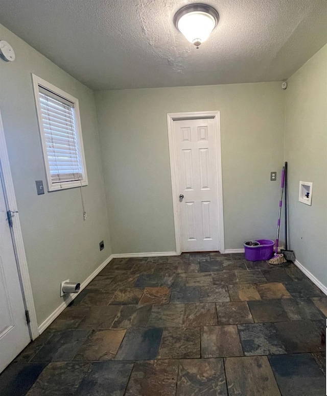 washroom featuring washer hookup and a textured ceiling